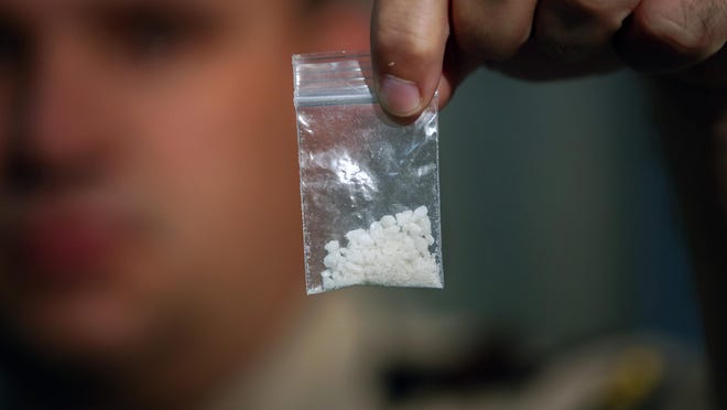 Lewis County (Kentucky) Sheriff Johnny W. Bivens holds up a small bag of flakka that was confiscated during an investigation.