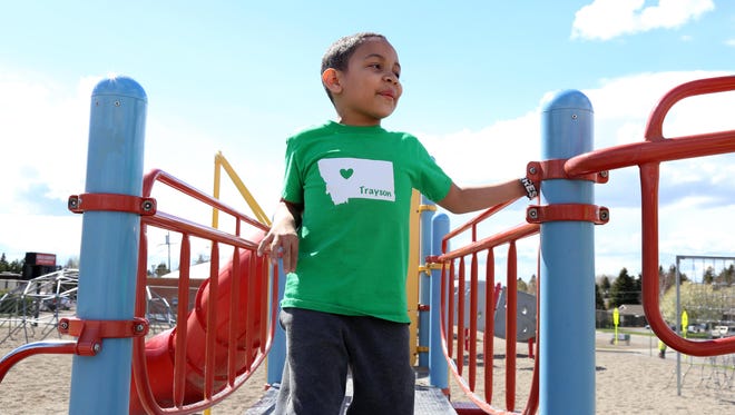Trayson Harrell plays on the Lincoln Elementary playground on his first day back to school.