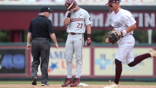 FSU’s Reese Albert covers his face in shock as his deep fly ball is caught at the wall by Mississippi State’s Elijah MacNamee during their NCAA Regional game at Dick Howser Stadium in Tallahassee, Fla. On Saturday, June 2, 2018. 