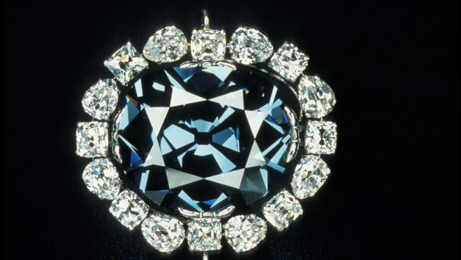 In this photo from the Smithsonian Institution,The Hope Diamond is seen in Washington. The famed diamond glows a mysterious red when exposed to ultraviolet light.