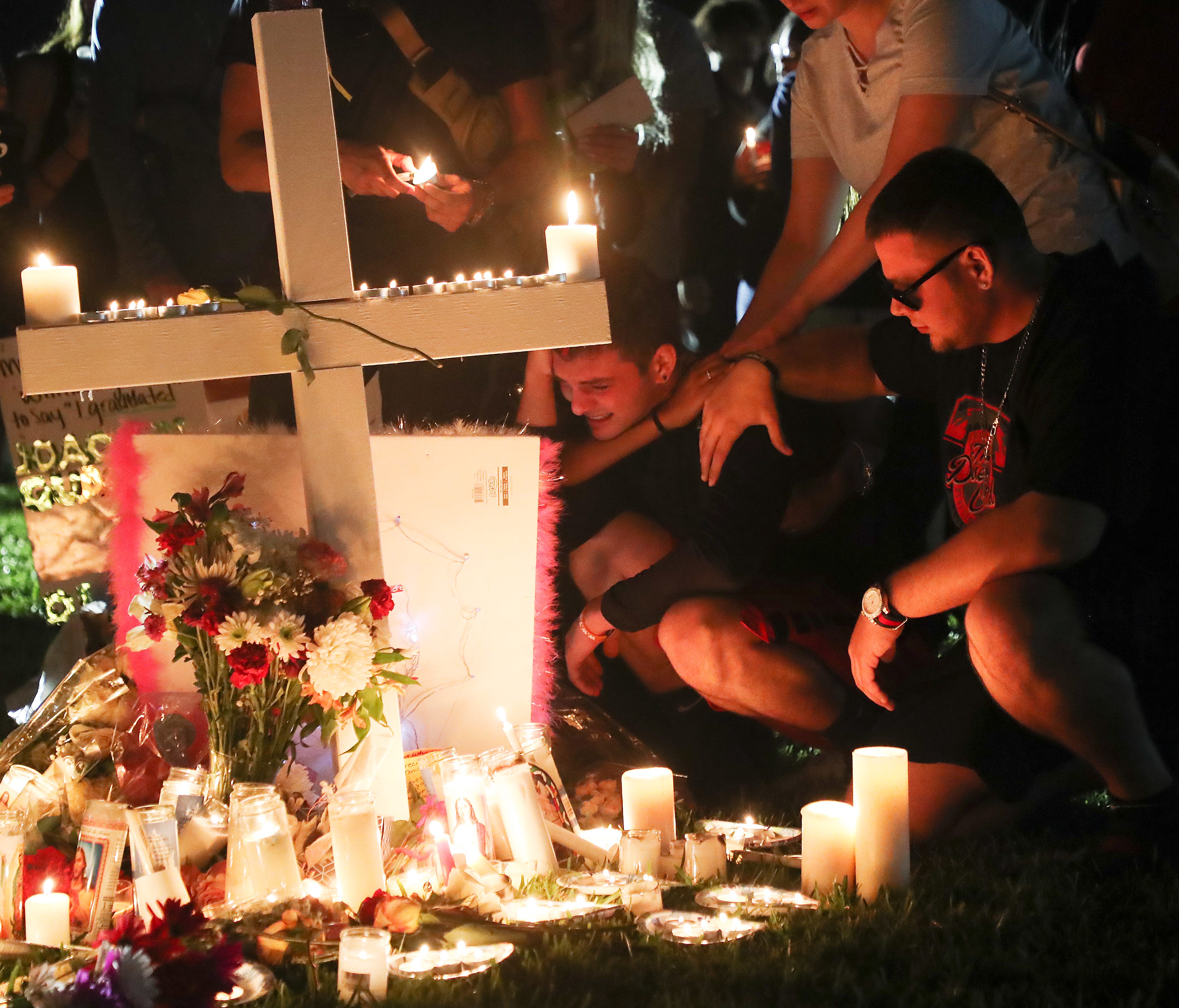 Mourners attend a candlelight vigil for those slain and injured in a mass shooting at Marjory Stoneman Douglas High School at the Parkland, Fl,  Amphitheatre on Thursday 2/15/2018. Thousands were in attendance.