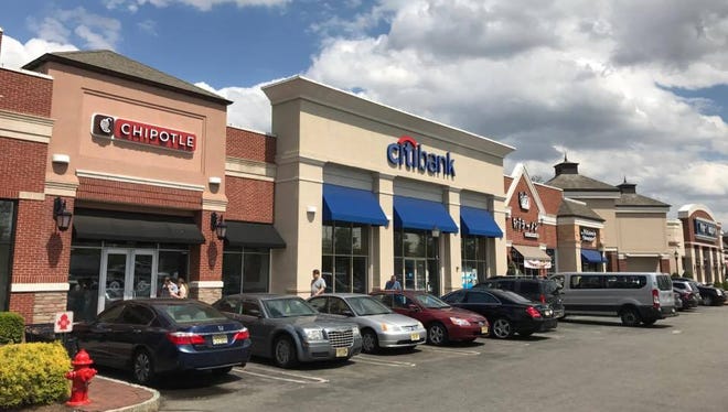 A woman was scammed into withdrawing $300 from a Clifton Citibank last week after two suspects claimed her car had struck their vehicle.