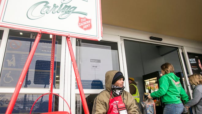 Volunteer Dominick Carter, of York City, rings the Salvation Army's Red Kettle bell, as shoppers walk past him Friday, Dec. 16, 2016, outside of West Manchester Town Center Walmart Supercenter. The Salvation Army's annual Red Kettle campaign has been underway since November 17. Thus far, the campaign is more than $30,000 short of last year's collection. "Please give generously to help your neighbors in need." Amanda J. Cain photo