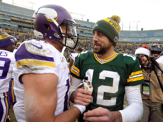 Green Bay Packers quarterback Aaron Rodgers (12) greets