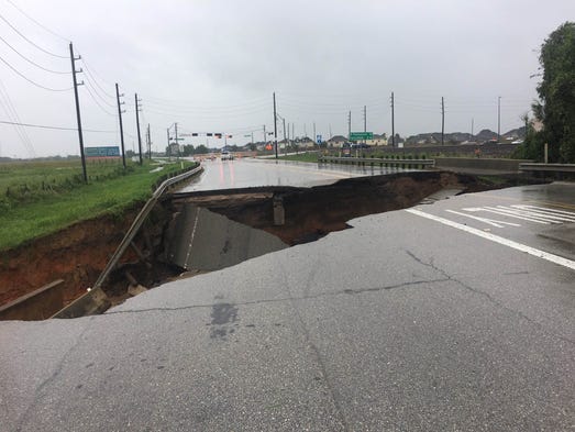 A view of a sinkhole that caused a road collapse along