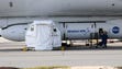 Technicians work on the Pegasus XL ocket slung beneath