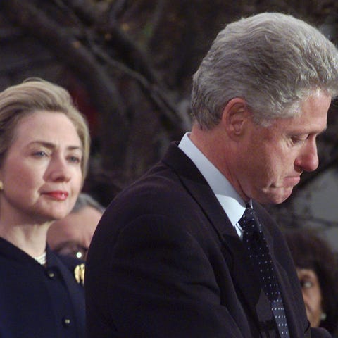 First lady Hillary Clinton looks on as President B