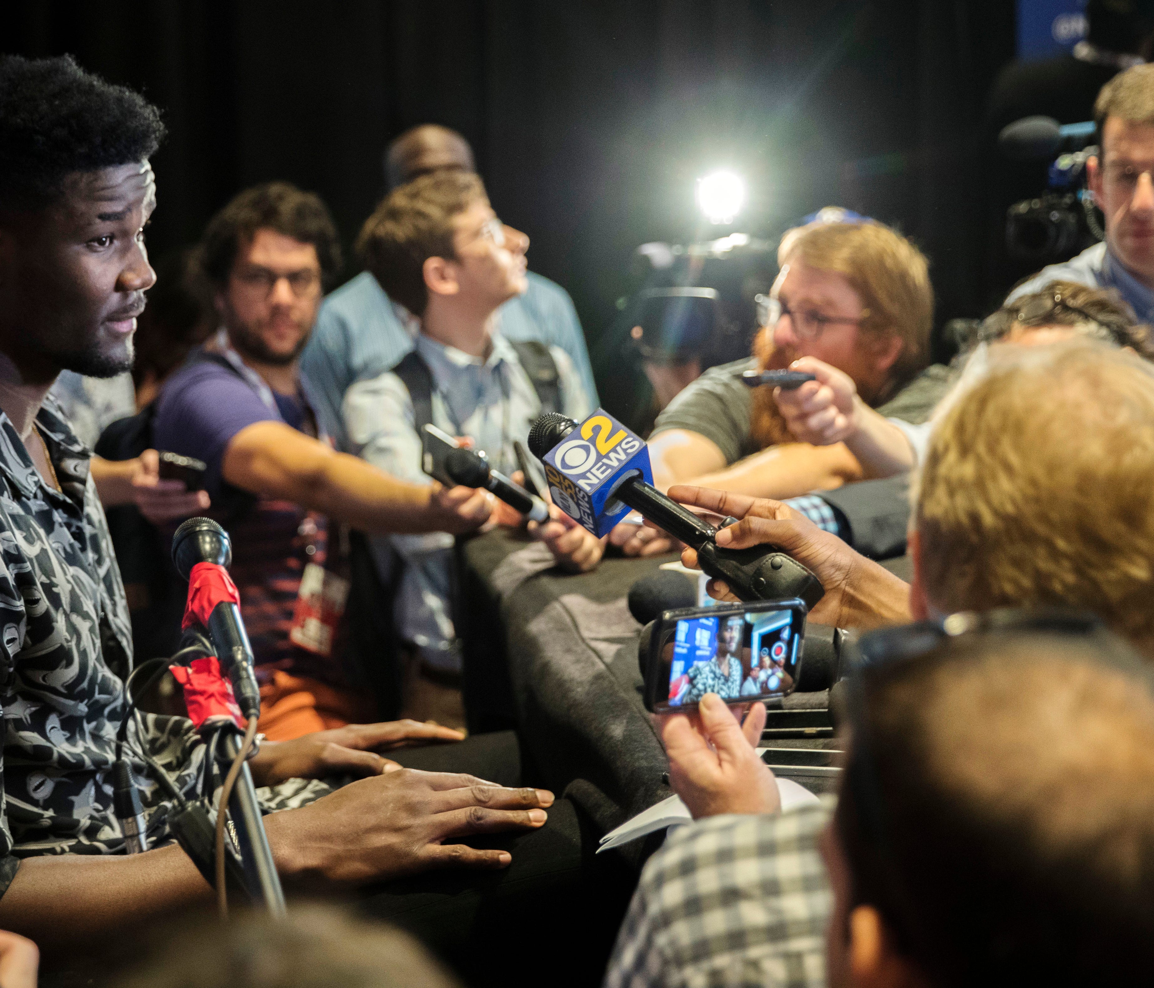 Arizona's DeAndre Ayton, left, speaks to reporters during a media availability with the top basketball prospects in the NBA Draft, Wednesday, June 20, 2018, in New York. (AP Photo/Mary Altaffer)