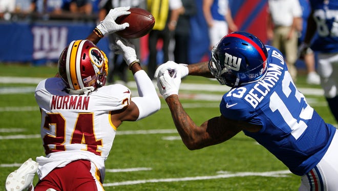 Washington cornerback Josh Norman fights for control of the ball with New York Giants' Odell Beckham Jr. on Sept. 25. Washington and New York meet again Sunday.