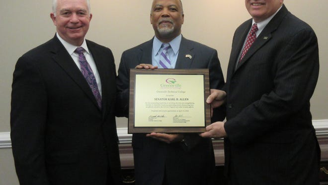Keith Miller, left, Greenville Technical College president, and Steve Hand, right, director of SPICE program at GTC, present award to Sen. Karl Allen for his support of job skills programs for ex-offenders and the under-skilled.