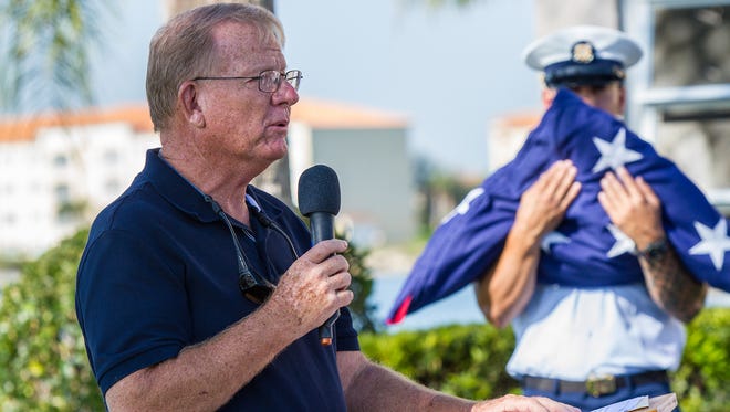 Retired Rear Adm. William Lynch addresses his fellow residents of the Colonnades adult community and guests during dedication ceremonies for a towering flagpole overlooking the Indian River Lagoon.