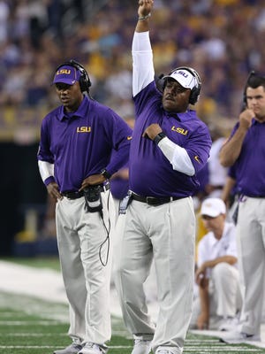 LSU Tigers defensive backs coach Corey Raymond (left) and defensive line coach Brick Haley on the sidelines during a recent game.