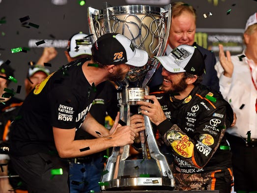 Martin Truex Jr. (78) celebrates with crew chief Cole