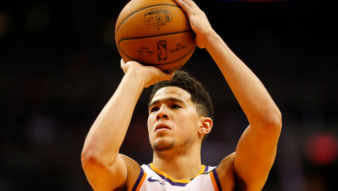 Phoenix Suns guard Devin Booker (1) shoots a free throw against the Oklahoma City Thunder during the first quarter at Talking Stick Resort Arena in Phoenix January 7, 2018.