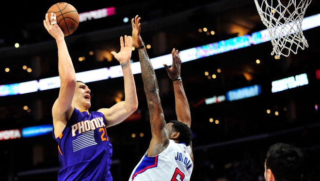 Phoenix Suns  center Alex Len (21) shoots against the defense of Los Angeles Clippers center DeAndre Jordan (6) during the first half at Staples Center in Los Angeles on Nov. 15, 2014.