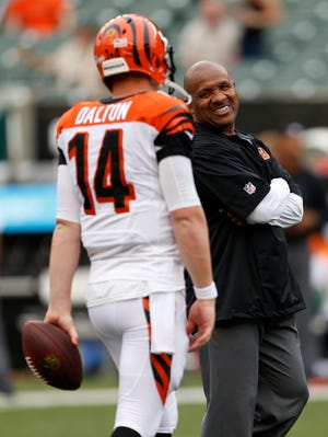 Bengals quarterback Andy Dalton talks with offensive coordinator Hue Jackson before a preseason game in August.