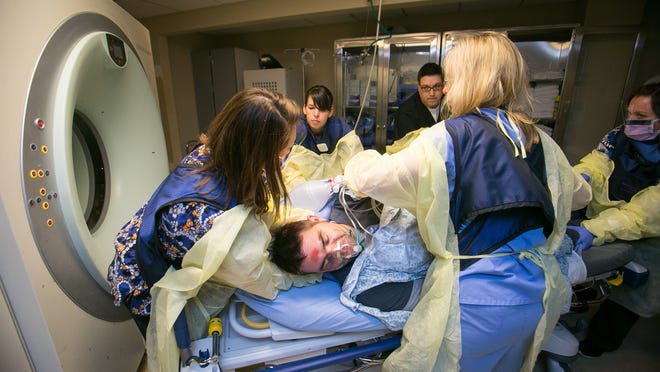 
Medical staff attend to a mock trauma patient, Joe Barcala, who pretends to be injured during a drill at Chandler Regional Medical Center, which becomes a Level
I trauma center starting Monday, March
24. 
