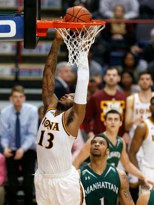 Iona forward David Laury (13) scores a basket in front of Manhattan forward Ashton Pankey during the second half of an NCAA college basketball game in the MAAC conference tournament championship on Monday, March 9, 2015, in Albany, N.Y. (AP Photo/Mike Groll)