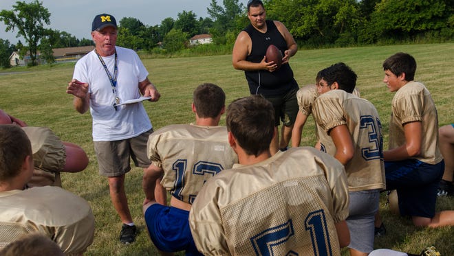 New Memphis varsity football coach Larry Bradkey talks to his team during a practice at Memphis High School.