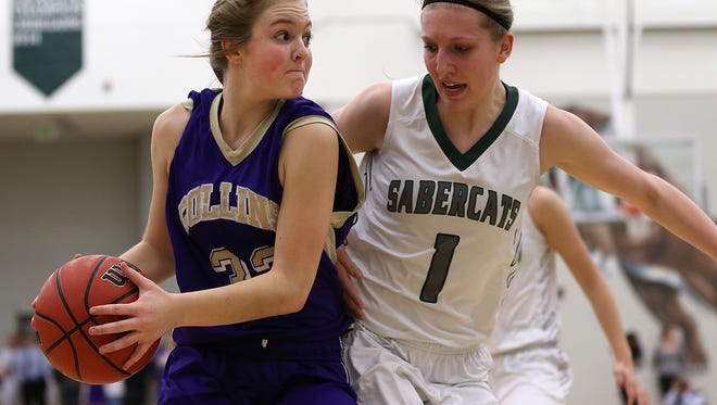 Fort Collins’ guard Emily Williams looks for an open shooter while Fossil Ridges’ Sami Steffeck defends during Fossil Ridge's 50-42 win over the Fort Collins Lambkins on Friday, Feb. 12 at Fossil Ridge High School.