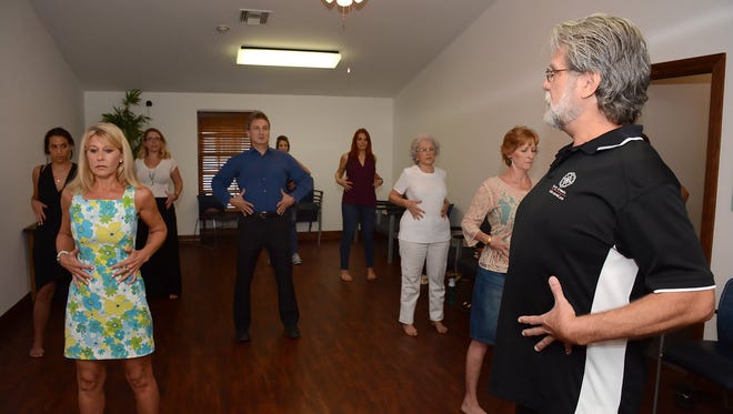 Harry Grimm, right, leads a group through foundation training. The Be Well Natural Health Clinic on Goodlette-Frank Road brings together multiple practitioners of holistic and alternative medicine under one roof.