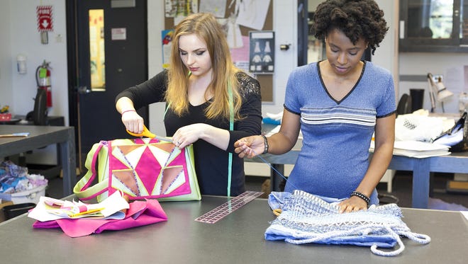 Rowan College at Burlington County students Mariya Barykina (left) and Jurnee Wade, work on the purses they created in their class. They were among 15 RCBC students who had their creations selected to be auctioned off at the annual "Power of the Purse" charity event by the American Red Cross Southwestern New Jersey chapter. The event is slated for May 18 at The Merion in Cinnaminson.