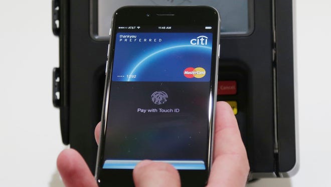Apple Pay is demonstrated at Apple headquarters in Cupertino, Calif.