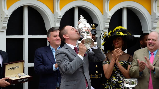 May 20, 2017; Baltimore, MD, USA; Cloud Computing trainer Chad Brown kisses the trophy after winning the 142nd running of the Preakness Stakes at Pimlico Race Course. Mandatory Credit: Patrick McDermott-USA TODAY Sports