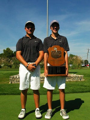 The Schmidt brothers - from left, Will and Kyle - hold the Greater Miami Conference trophy after their win.