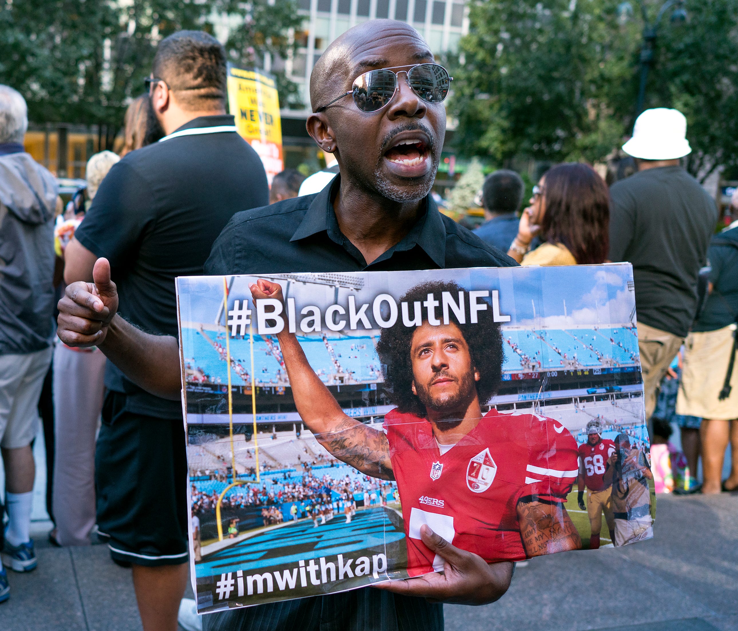 Eric Hamilton of New York joins others gathered in support of unsigned NFL quarterback Colin Kaepernick on Wednesday, Aug 23, 2017, in front of NFL headquarters in New York.