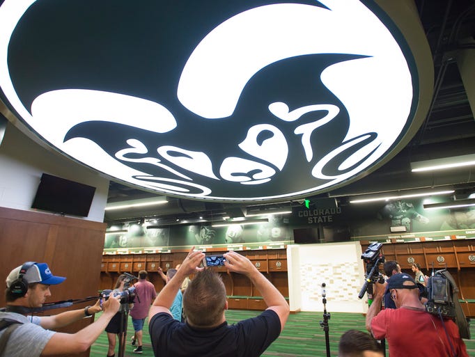 Media personnel take photos of a Rams logo in the CSU