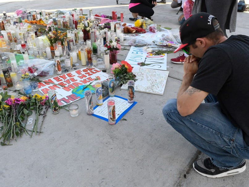 On Oct. 3, 2017, Ken Neyhart of Las Vegas sits quietly at a makeshift memorial honoring the victims of an Oct. 1, 2017, mass shooting during the Route 91 Harvest music festival.