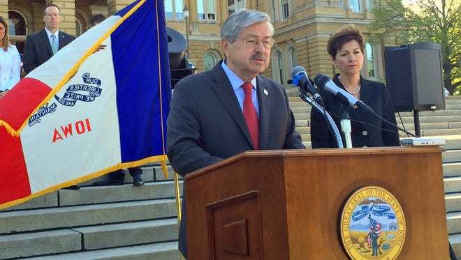 Gov. Terry Branstad talks with reporters Monday outside the the Iowa Capitol. At his right is Lt. Gov. Kim Reynolds. Branstad said he won't endorse a candidate in the Steve King-Rick Bertrand Republican primary race.