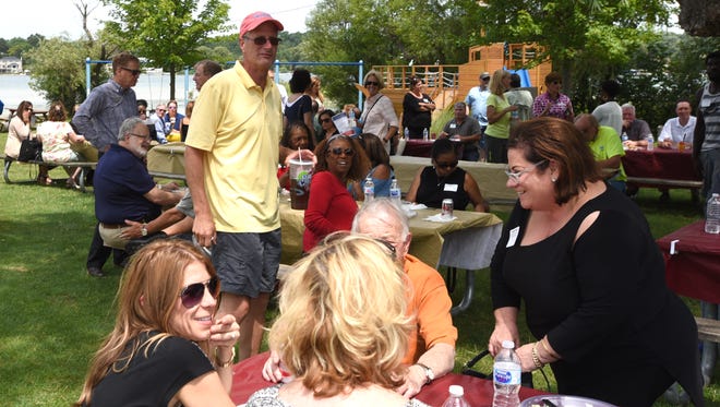 Michigan Home Builders Association CEO Michael Stoskopf, center, and others gather at Walnut Lake Estates on July 26 for a networking barbeque.