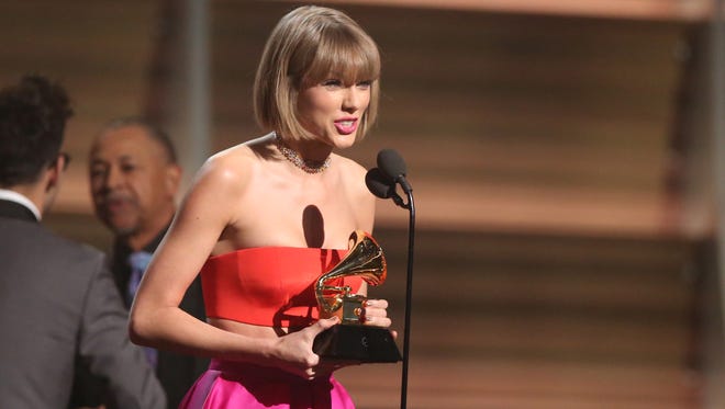 Taylor Swift accepts the award for album of the year for 1989 at the 58th annual Grammy Awards on Monday, Feb. 15, 2016, in Los Angeles. (Photo by Matt Sayles/Invision/AP)