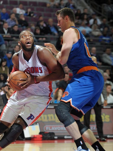 The Pistons' Greg Monroe drives around the Knicks'