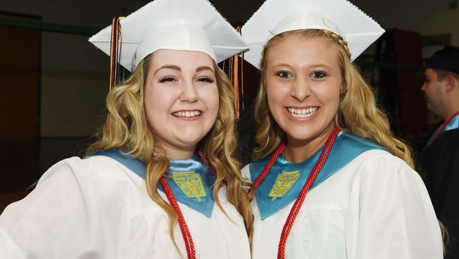 Graduating seniors Maryrose Myers, left, and Krista Caione, right, pose before lining up for Dover High School's 2016 graduation ceremony. 
