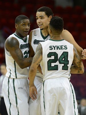 UW-Green Bay's Daeshon Francis (23), Jordan Fouse (4) and Keifer Sykes (24) celebrate after Sykes made a dunk against Wright State during Monday night's Horizon League game at the Resch Center in Ashwaubenon. Evan Siegle/Press-Gazette Media