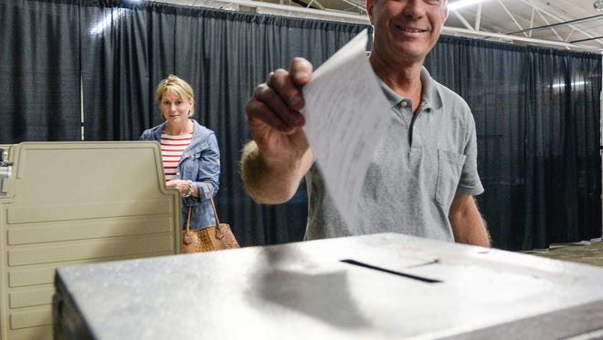 Jeffrey Roberts casts his ballot near Danielle Roberts, left, at the Anderson University Sports Complex on Tuesday. Roberts was elected to replace his father on the Anderson City Council.