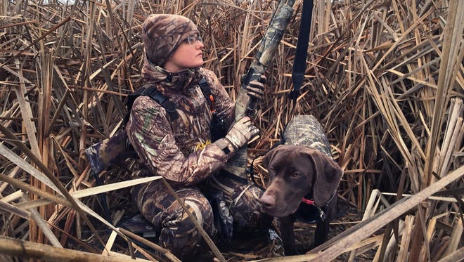 Tiffany Compton, Indianapolis, hunts with her dog Oakley on Dec. 6, 2014, at Indiana Department of Natural Resources' Goose Pond Fish and Wildlife Area near Linton.