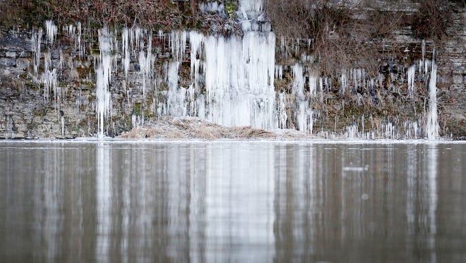 Water freezes on the rock face across the Chemung River at Bottcher's Landing in Big Flats Tuesday.