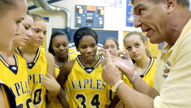 Naples High School head coach Dave Walker goes over a few last-minute points with his team right before a game on Nov. 21, 2005. Walker won 611 games as the Eagles' coach from 1979-2012.
