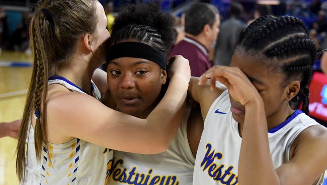 Westview's Tasia Jones tears up while receiving hugs from Westview's Aubrey Hubbard and Zanasha Gadlen after their win over Alcoa in the 2018 Class AA quarterfinals, Thursday, March 8, in Murfreesboro.