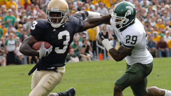 Notre Dame running back Darius Walker (3) gets tackled by Michigan State safety Greg Cooper (29) during the first quarter Saturday, Sept. 17, 2005, in South Bend, Ind.