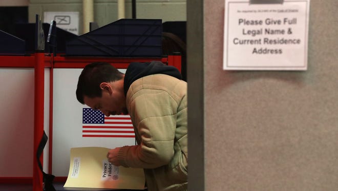 A voter casts his ballot in a polling place on Election Day Nov. 8, 2016 in Alexandria, Virginia.