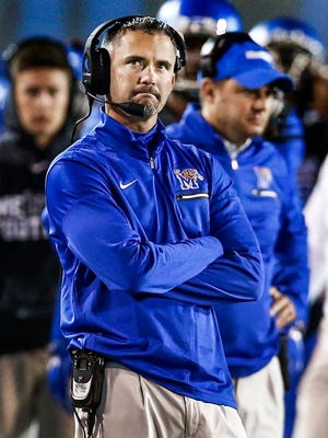 Dejected University of Memphis head coach Mike Norvell looks on as the Tigers fall to the University of South Florida 49-42 at the Liberty Bowl Memorial Stadium.  