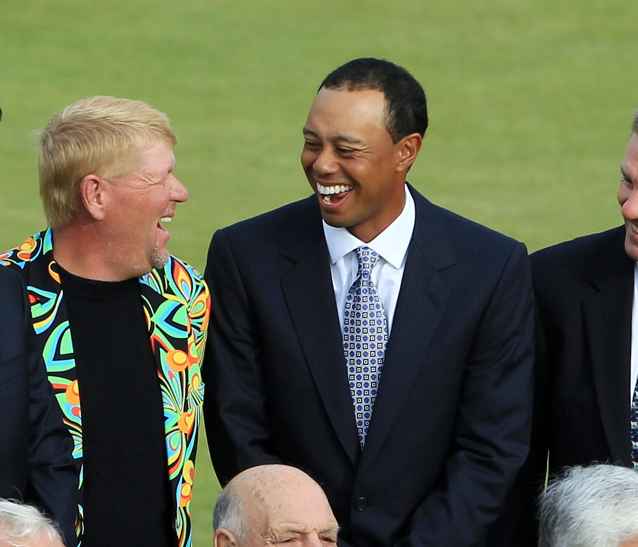 ORG XMIT: XSTA231 Former British Open Champions, from left, Padraig Harrington of Ireland, John Daly of the U.S., Tiger Woods of the U.S. and Bill Rogers of the U.S. laugh together before the group photo on the 1st tee on the Old Course at St. Andrew