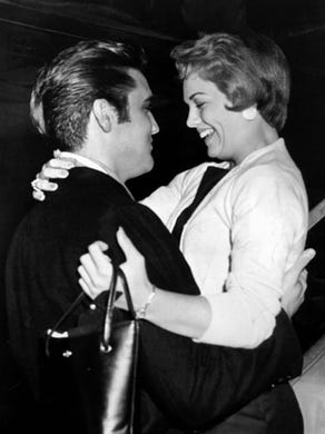 Elvis Presley and Anita Wood embrace as she steps from an airliner at Memphis Municipal Airport the night of Sept. 13, 1957. Miss Wood, hostess for a Memphis TV show, 'Top 10 Dance Party,' was returning from a week in Hollywood preparing for her first movie role in 'Girl in the Woods.' Elvis had given the 19-year-old a friendship ring the previous week in Hollywood.