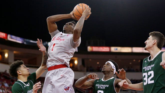 Fresno State's Jaron Hopkins goes up for a shot between CSU defenders, from left, Anthony Bonner, Raquan Mitchell and Nico Carvacho, during Saturday's game at the Save Mart Center in Fresno, Calif. The Bulldogs won 86-65, sending the Rams to eight loss in the past nine games.