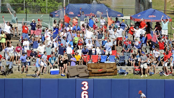 Students celebrate a home run by Mississippi's Sikes Orvis during the fifth inning of an NCAA college baseball game against Arkansas in Oxford, Miss., Saturday, May 3, 2014. (AP Photo/The Daily Mississippian, Thomas Graning)